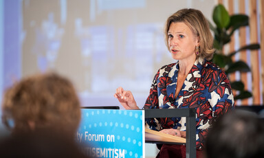 Woman stands at a podium