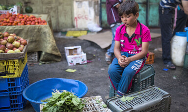 Boy sits on a crate 